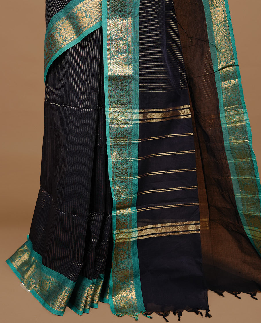 Black colour chettinad cotton saree featuring gold zari stripes on body, complemented by Green colour with zari border, paired with matching blouse piece.