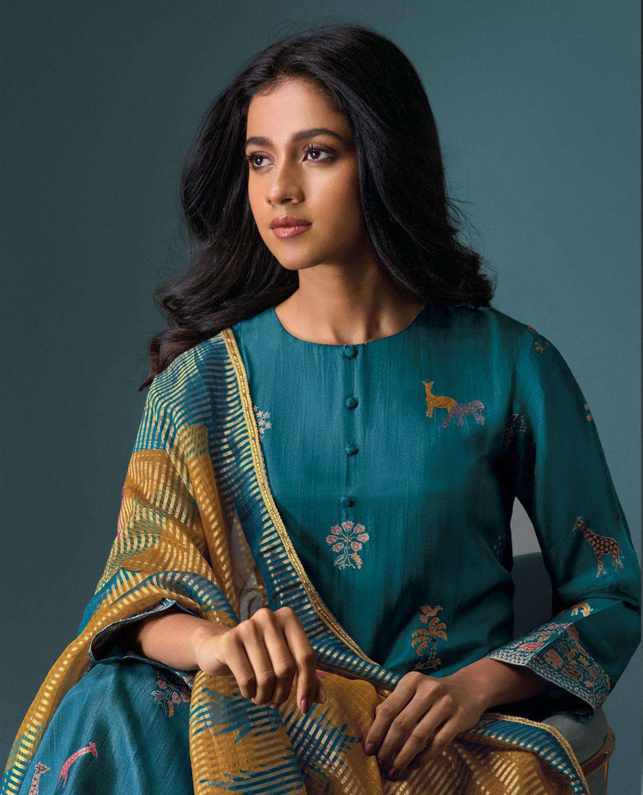 Teal colour suit material with Olivia silk jacquard top featuring elegant digital prints, paired with classic silk bottoms, and completed with a silk jari lining dupatta highlighted by digital prints