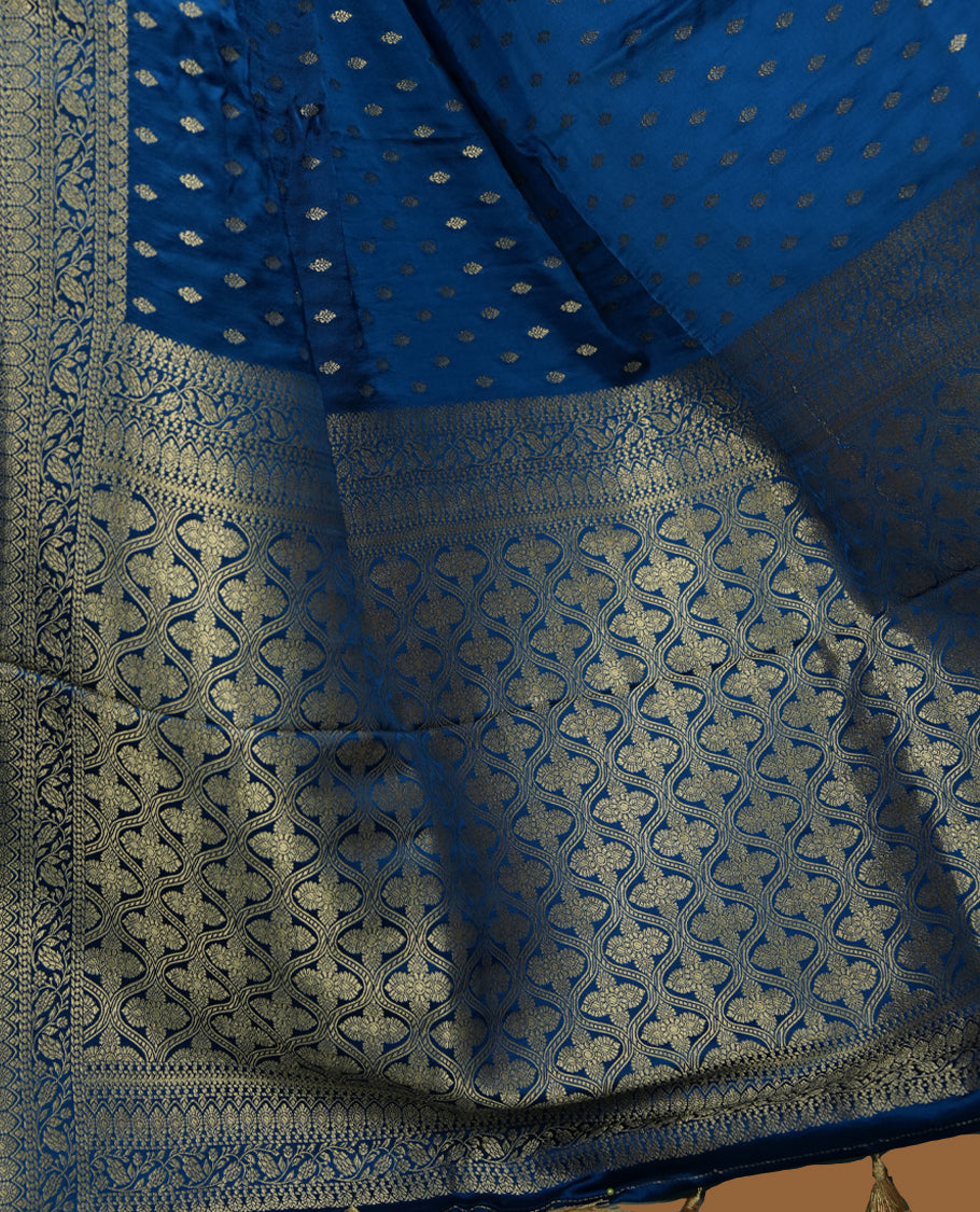 Royal Blue Colour Semi Banarasi Satin Crepe Saree with Silver Zari Buti Motifs, Traditional Gold Floral Pallu, Elaborate Woven Border, Decorative Tassels with Matching Blouse