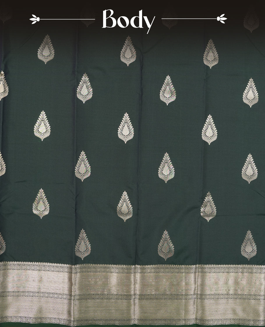 Dark Green colour semi soft silk saree featuring a gold leaf patterned body, complemented by gold traditional pallu & border and a matching blouse piece.