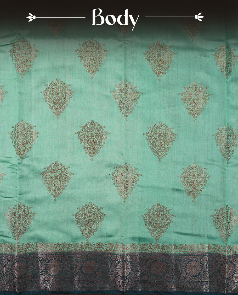 Mint Green Colour Banaras Soft Silk Saree with Gold Zari Diamond Leaf Buttas, Intricate Multi-Layered Floral Border, Grand Pallu with Ornate Sunflower Motifs in Dark Green and Gold Tones, and Matching Teal Blouse.