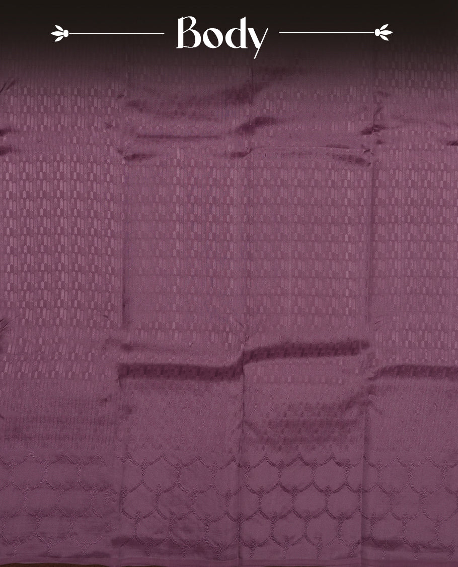 Dark mauve colour semi soft silk saree featuring a self coloured textured patterned body, complemented by self coloured motifes on pallu & border and a matching blouse piece.