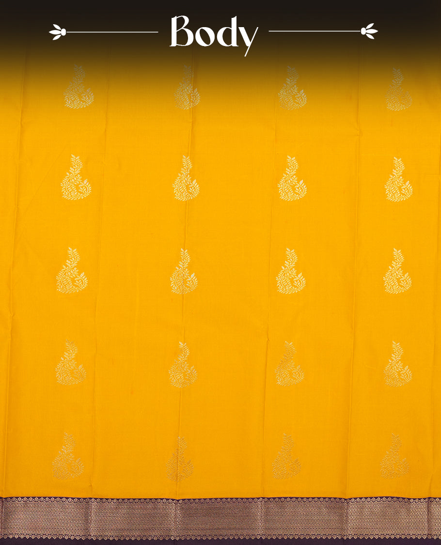 Gold yellow colour Semi Silk Saree with gold zari patterns on the body, paired with a contrasting dark violet colour traditional pallu and border, and a matching blouse piece.