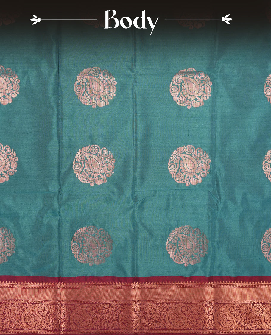 Teal colour Semi Silk Saree with gold zari motifs on the body, paired with a contrast Dark maroon colour pallu with gold zari traditioal border, and a matching blouse piece.