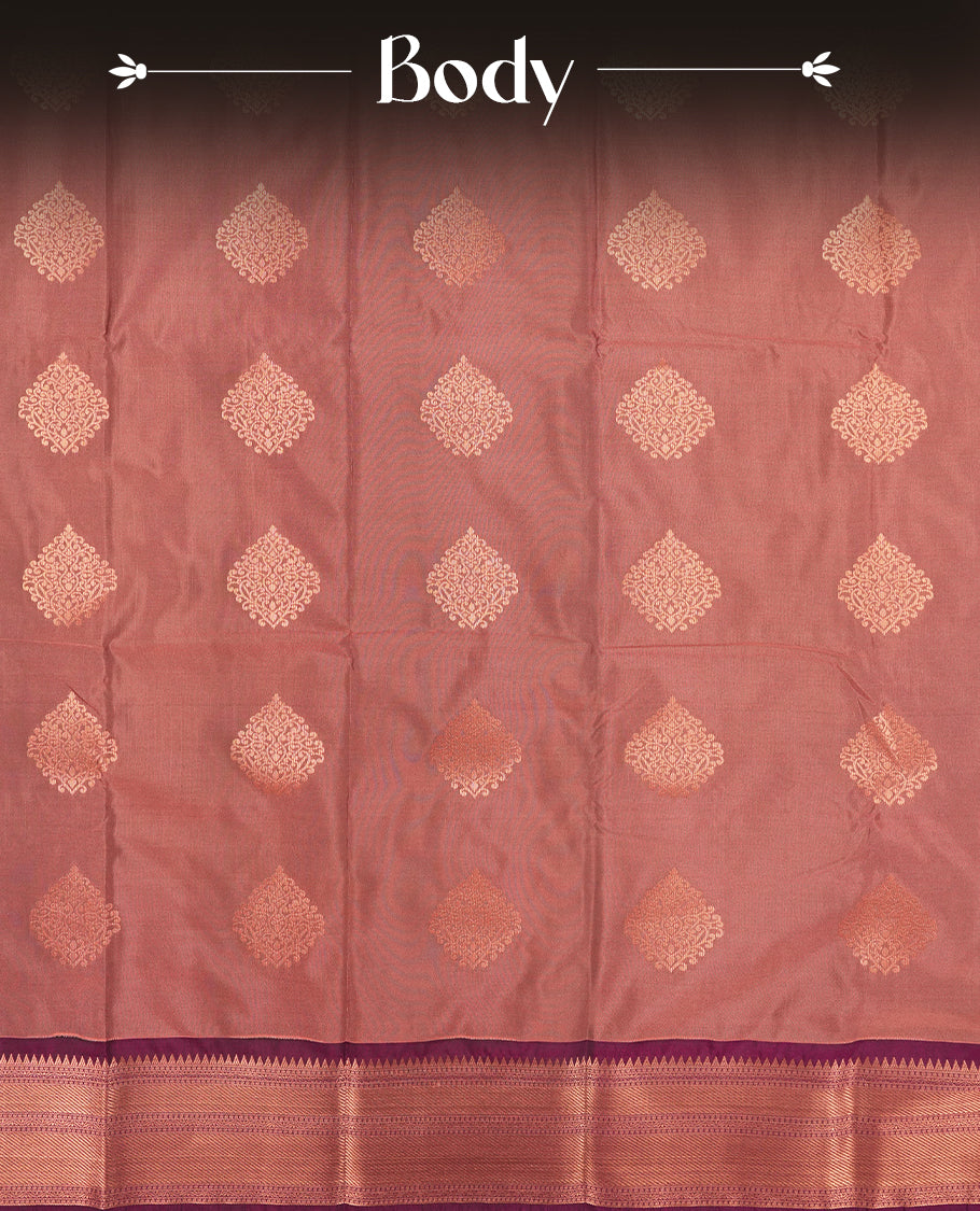 Dusty Rose colour Semi Silk Saree with copper zari motifs on the body, paired with a contrast Dark purple colour pallu with copper zari traditioal border, and a matching blouse piece.