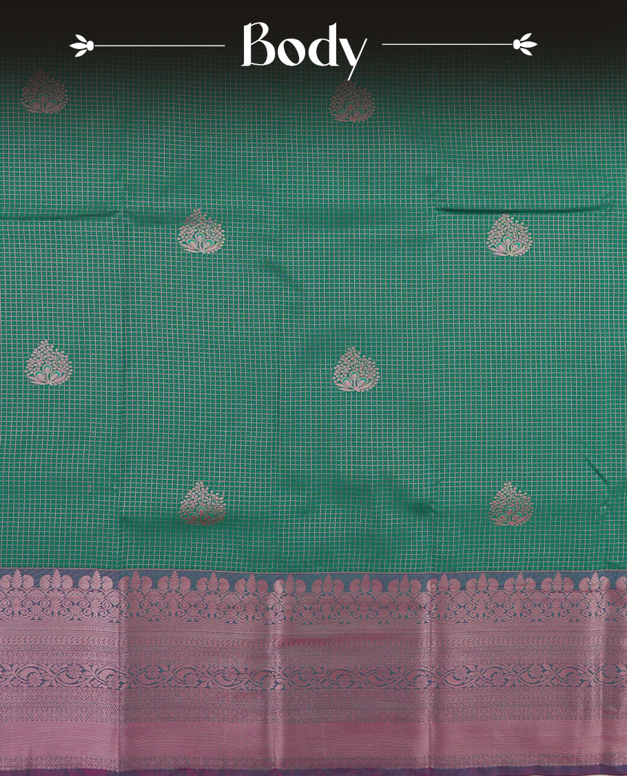 Pine green colour Semi Silk Saree with rose gold zari checkered on the body, paired with a contrast Teal green colour pallu with rose gold zari traditioal border, and a matching blouse piece.
