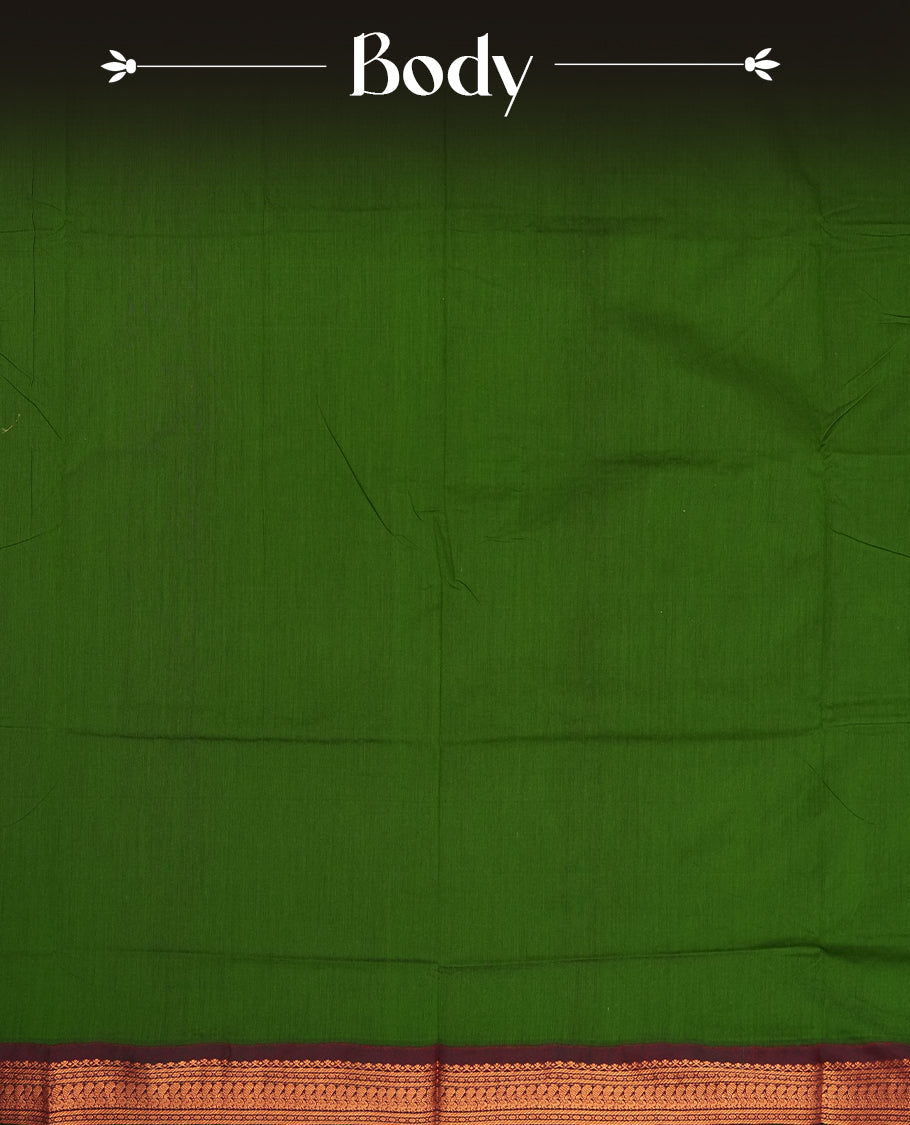 Deep forest green colour Kalyani Cotton saree with rich maroon border and pallu, featuring copper zari peacock motifs and intricate weaving & Includes a matching blouse piece.