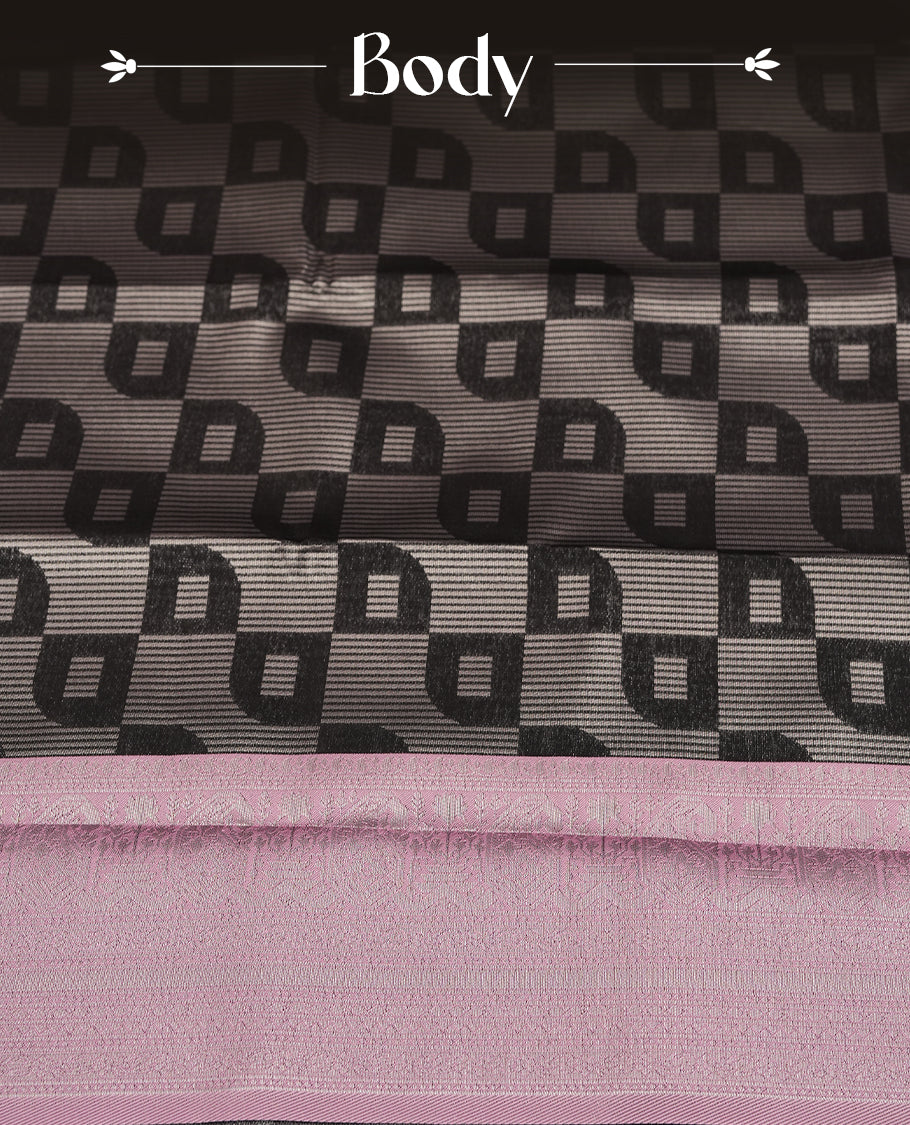 Black colour semi silk saree adorned with silver zari designs on the body, complemented by a contrasting light pink border and pallu, and paired with a matching blouse piece