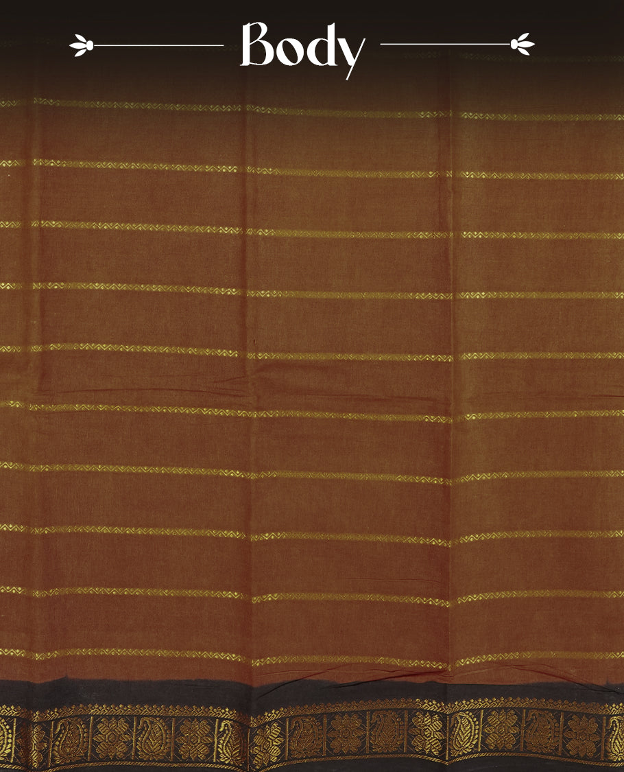 Brown colour Chettinad cotton saree accentuated with golden zari stripes all over, The contrasting black border with intricate floral motifs in golden zari & Comes with a matching blouse piece.