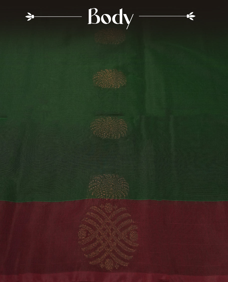 Dark greeen colour soft silk cotton saree adorned with copper zari motifs and a shimmering copper zari border, Enhanced by a beautifully rich maroon colour woven pallu & Comes with a matching blouse piece for a complete look.