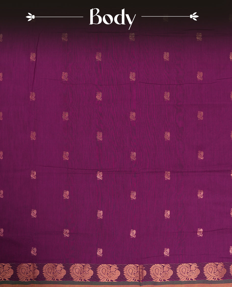 Purple colour Kalyani Cotton saree in deep green with golden peacock motifs, paired with a contrasting green border featuring intricate zari work & Comes with a matching blouse piece.