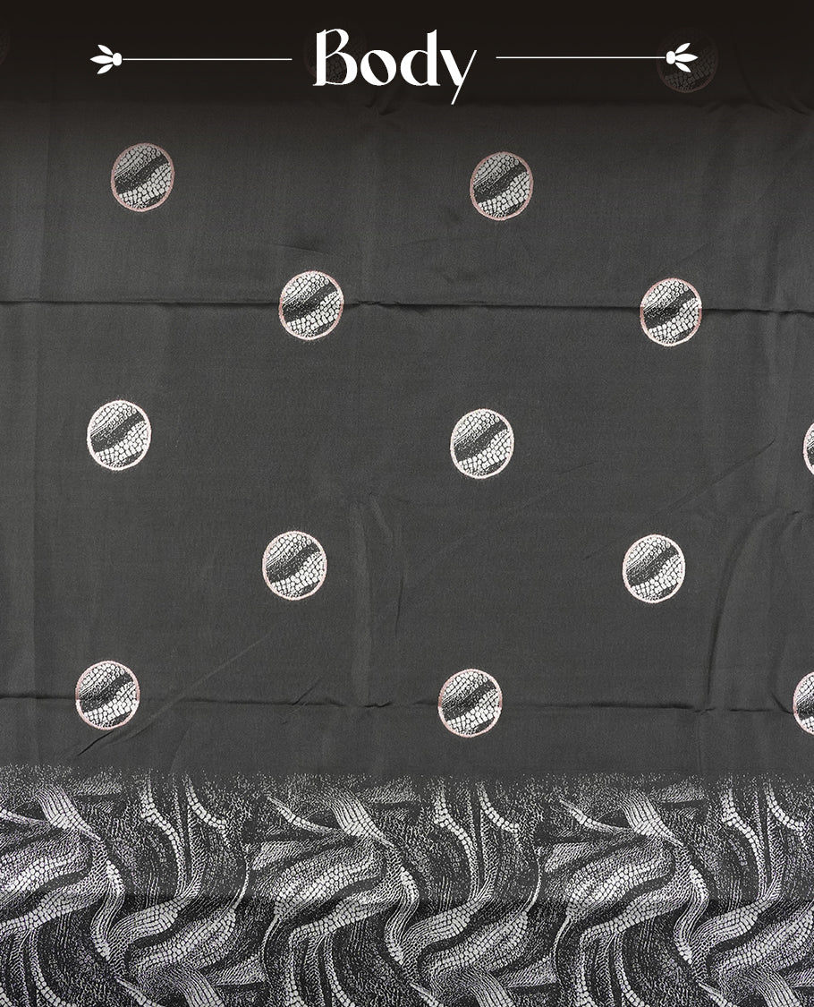 Black colour semi silk saree featuring elegant circular motifs on the body, complemented by white wavy designed pallu with striking border adorned with intricate golden thread patterns,and paired with a matching blouse