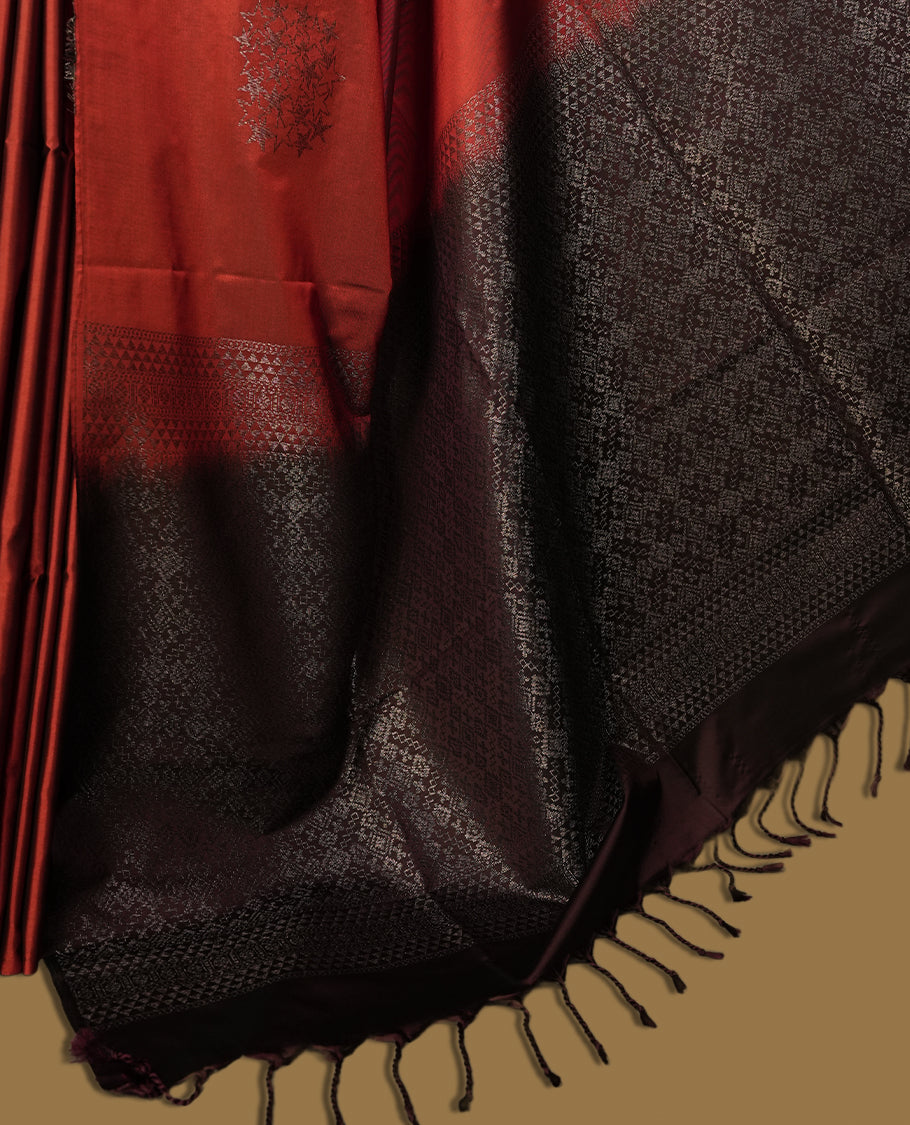 Deep copper colour semi soft silk saree adorned with delicate woven motifs on the body & Enhanced with a striking dark brown contrast zari border and elegant pallu, paired with a matching blouse.
