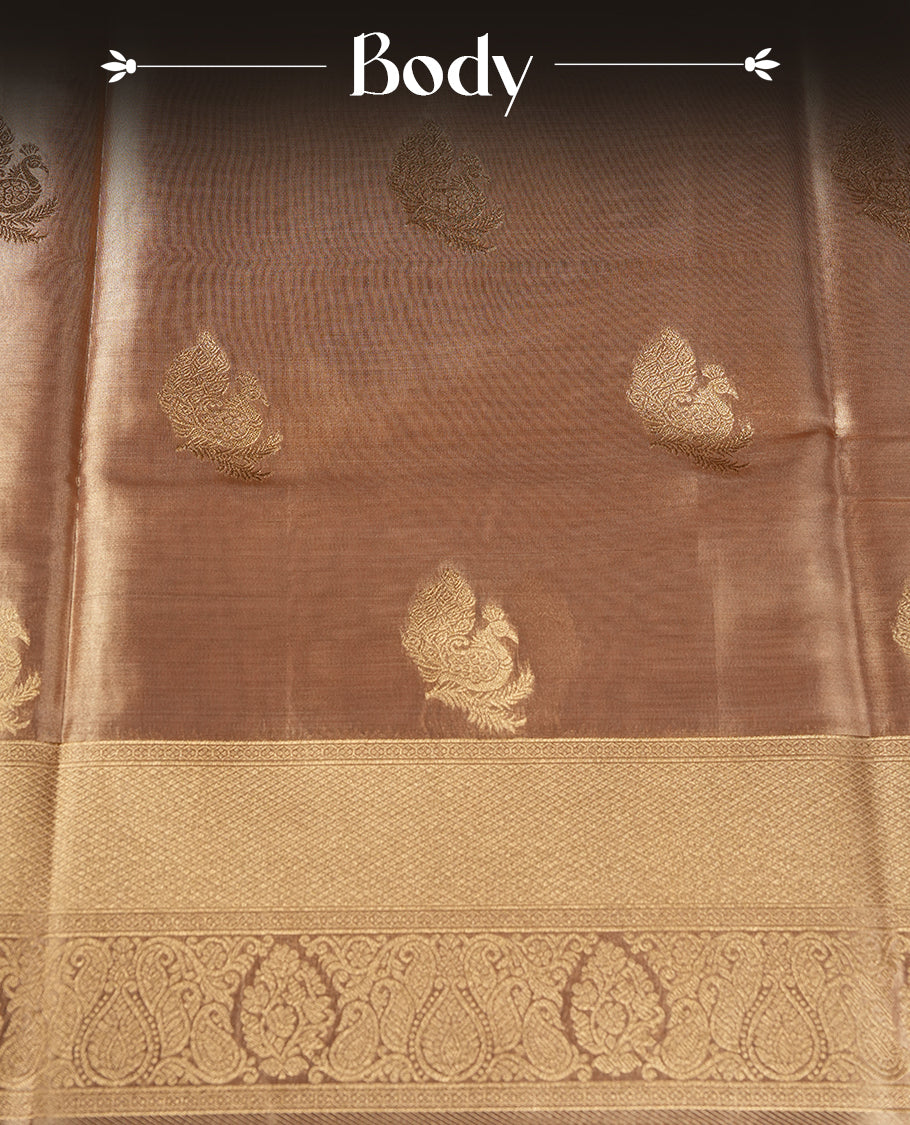 Gold colour tissue banaras silk saree featuring antique gold peacock zari motifs on the body with rich traditional zari border and pallu, paired with a matching blouse piece.