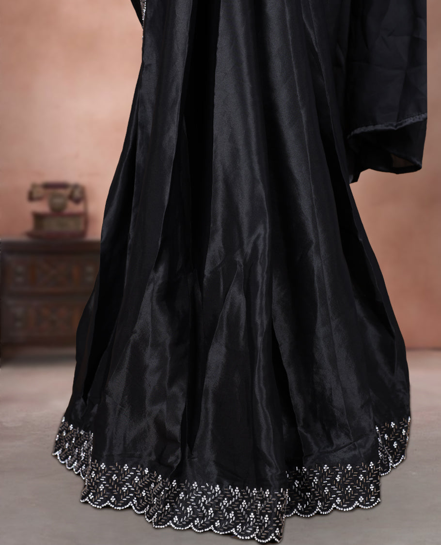 Elegant Black colour ready to wear saree adorned with rich white stone embroidery along the border and pallu, paired with a heavily embellished matching blouse for a grand festive look.