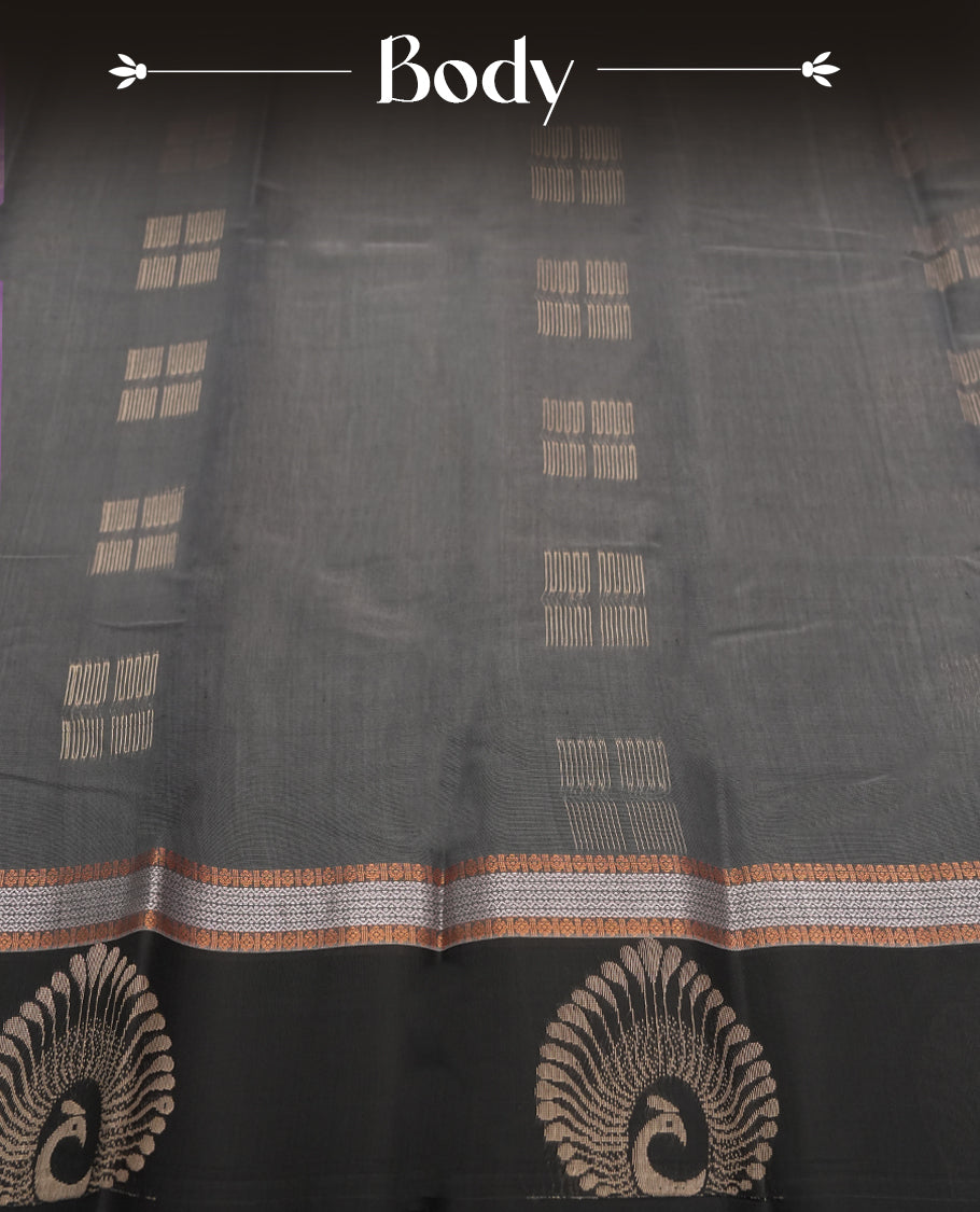 Black & Grey colour tissue cotton saree featuring elegant silver & copper zari motifs, a delicate zari border, and a beautifully woven pallu & Paired with a matching blouse, perfect for festive and traditional occasions.