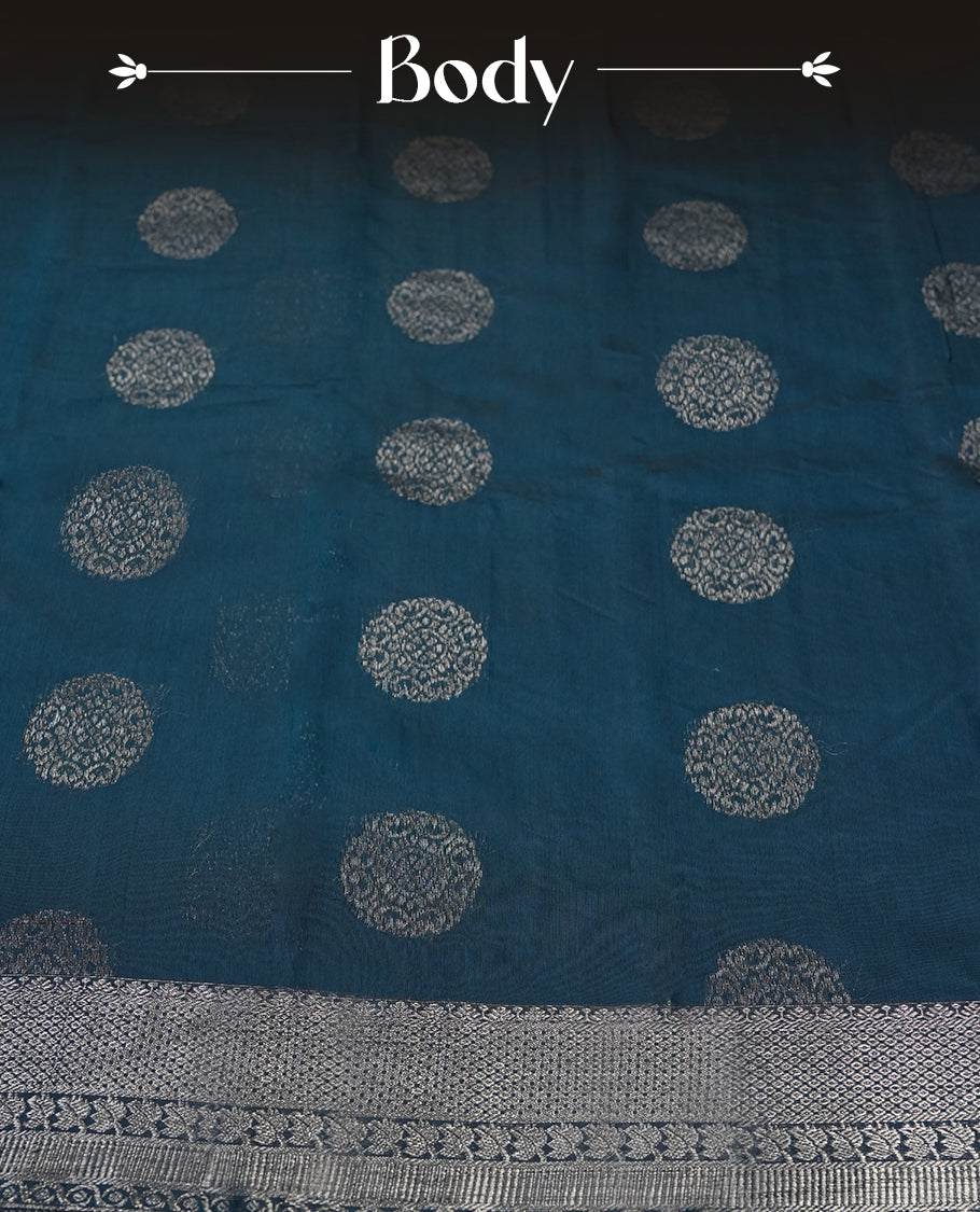 Cobalt blue colour silk cotton saree adorned with a shimmering silver zari border and intricate woven designs, blending elegance with tradition, Paired with a matching blouse, its perfect for festive and special occasions.