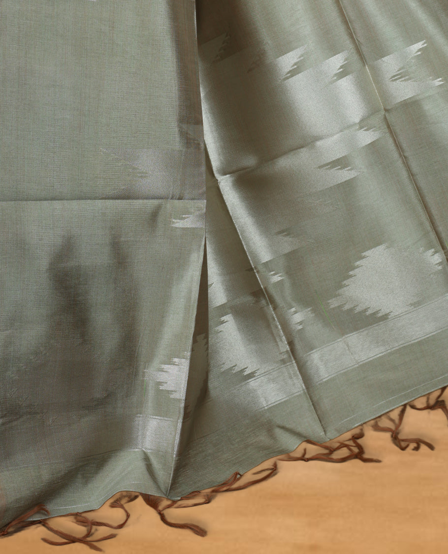 Gray and silver colour dual tone semi tussar saree featuring woven abstract geometric motifs on the body, complemented by a ikat inspired contrast olive patterned pallu, paired with a matching blouse.