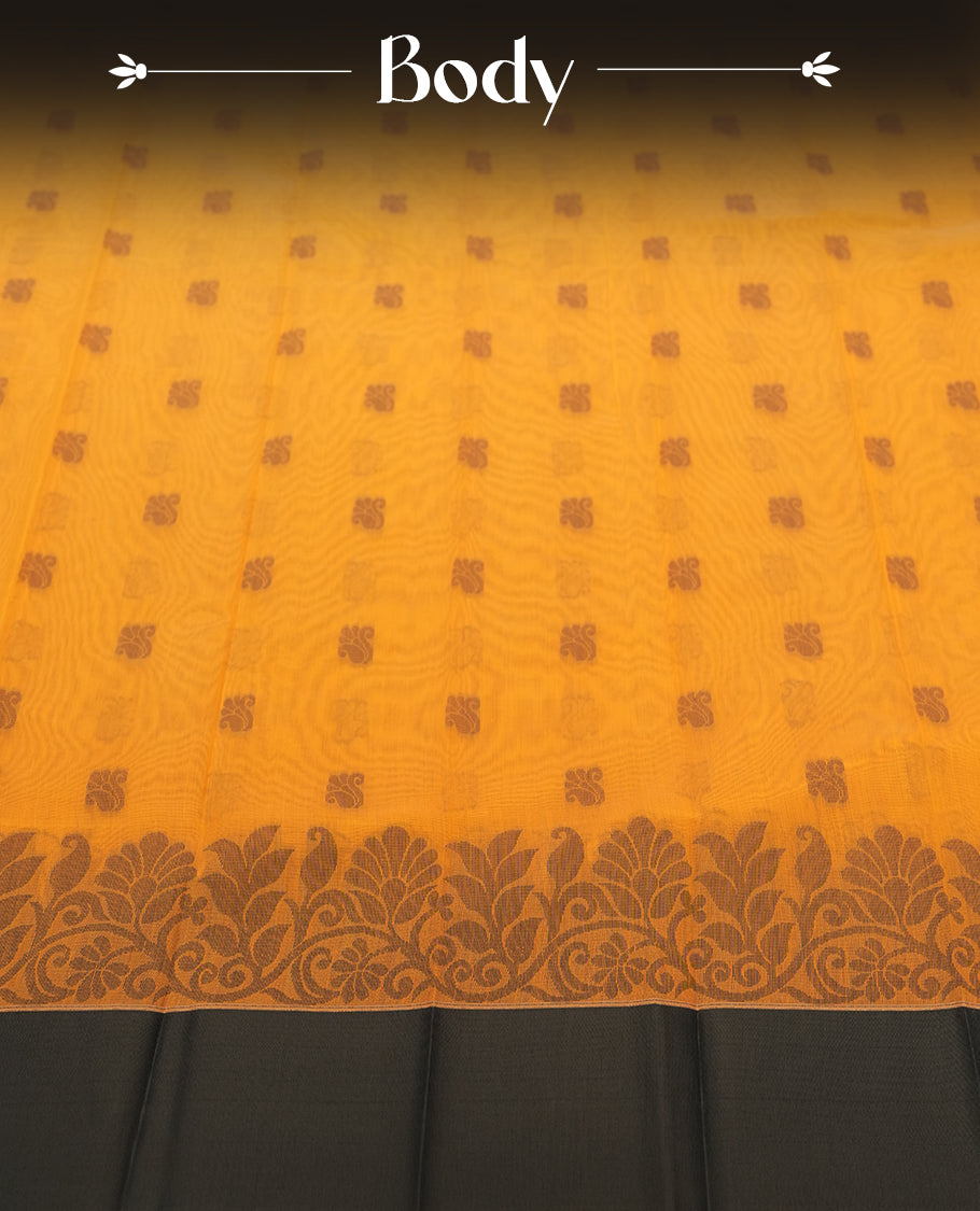 Saffron orange colour silk cotton saree featuring elegant grey floral and geometric woven motifs across the body, paired with a deep contrast grey border and pallu showcasing intricate traditional patterns & Comes with a matching blouse piece.