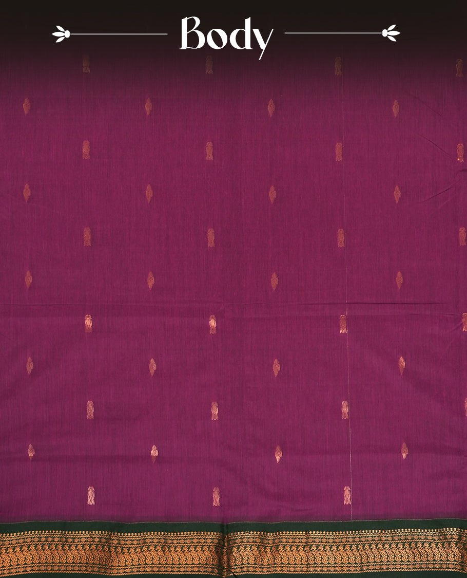 Purple colour Kalyani cotton saree with intricate small motifs all over, paired with a contrasting dark green rich zari woven border and pallu & Comes with a matching blouse piece