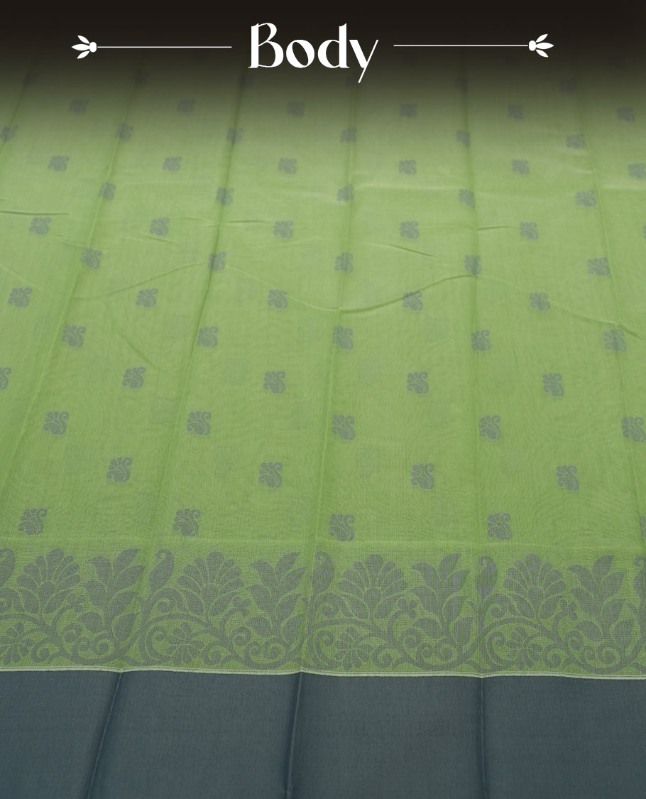 Moss green colour silk cotton saree featuring elegant floral zari motifs on the body, complemented by a rich contrast dark plain border and pallu with traditional woven detailing & Comes with a matching blouse piece.