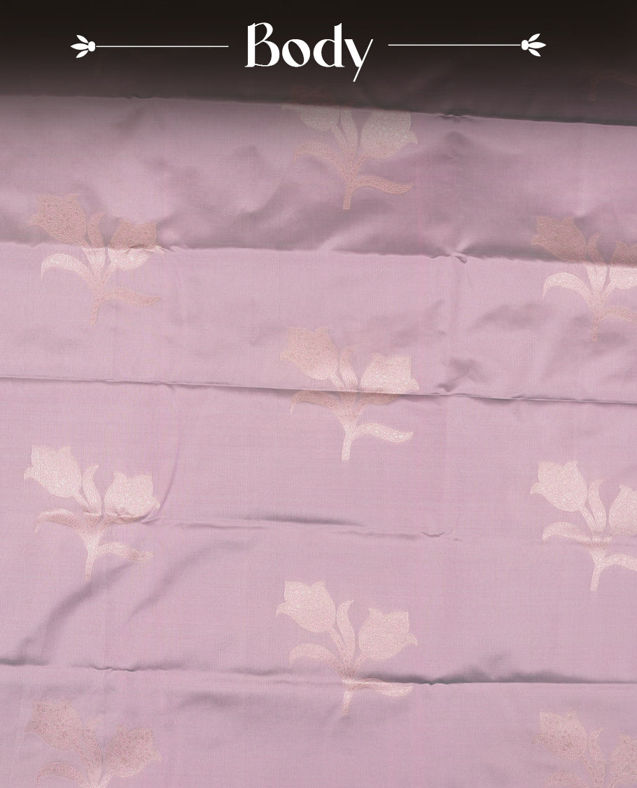 Dusty Lilac Semi Silk Saree with Subtle Zari Butta Motifs, Matching Pastel Lilac Zari Woven Pallu and Border with Intricate Floral Patterns and Tassels, Paired with Coordinated Blouse Piece