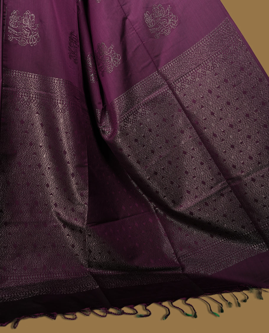Grape colour semi soft silk saree, adorned with subtle self woven motifs on the body & The design is elevated with an elegant zari border and pallu, paired with a matching blouse.