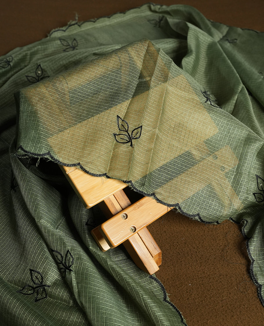 Olive colour churidhar material featuring Black colour thread embroidery on the front panel, self colour dupatta with elegant border, and matching plain bottom