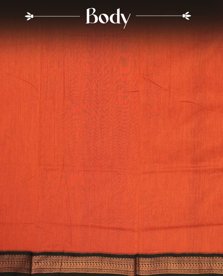 Rust orange colour Kalayani cotton saree highlighted with a black border adorned in intricate copper zari motifs, complemented by a matching pallu and blouse piece.