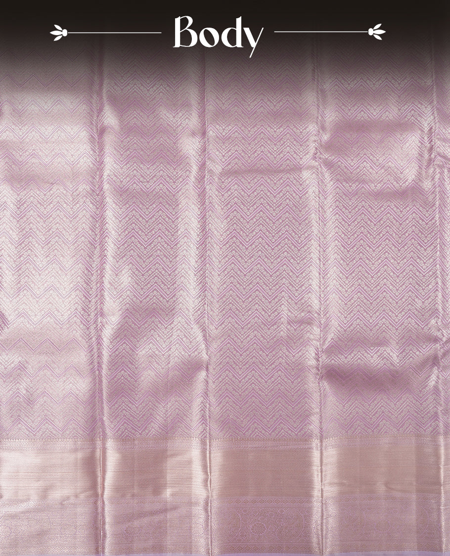 Light Lavender colour and silver Zari Tissue Brocade Saree features intricate Zigzag Motifs on body and self coloured border & pallu, paired with matching blouse
