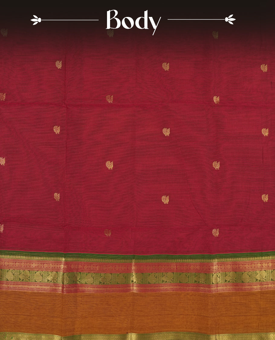 Dark marooon colour Chettinad cotton saree adorned with small peacock motifs on the body, it features a contrast maroon and brown border highlighted with intricate green and golden zari weaving & Comes with a matching blouse piece.