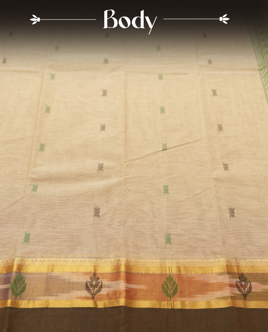 Beige Sand colour Silk Cotton Saree with Pastel Green Floral-Jacquard Pallu Panels and Chevron Bands, Body dotted with tiny thread buttas, Antique Gold Ikat-inspired border over Deep Olive lower edge, and a Plain Beige Sand Blouse with Matching