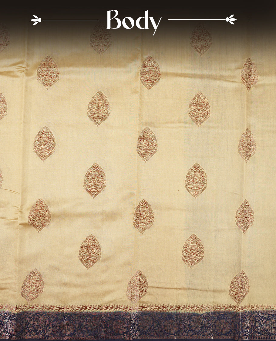 Cream Beige Colour Banaras Soft Silk Saree with Gold Zari Oval Mandala Buttas, Intricate Multi-Layered Decorative Pallu Border, Grand Pallu with Ornate Circular and Foliate Motifs in Navy Blue and Gold Tones, and Matching Navy Blue Blouse