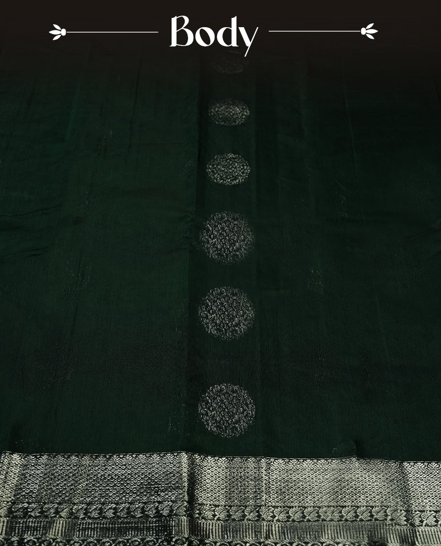 Dark green colour silk cotton saree with shimmering silver zari border and intricately woven pallu, blending elegance and tradition, Paired with a matching blouse, perfect for festive celebrations and special occasions.