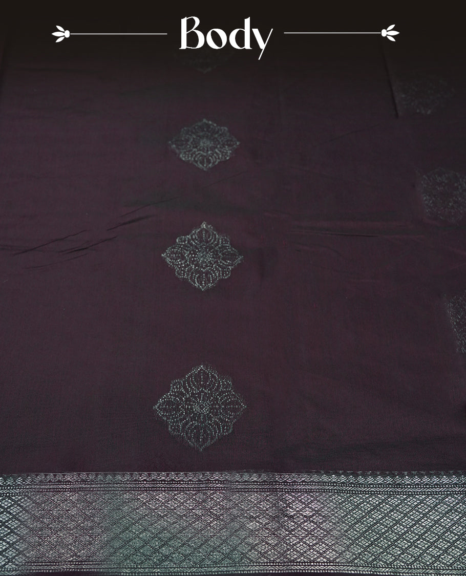 Wine colour silk cotton saree adorned with a shimmering silver zari border and intricate woven designs, blending elegance with tradition, Paired with a matching blouse, its perfect for festive and special occasions.