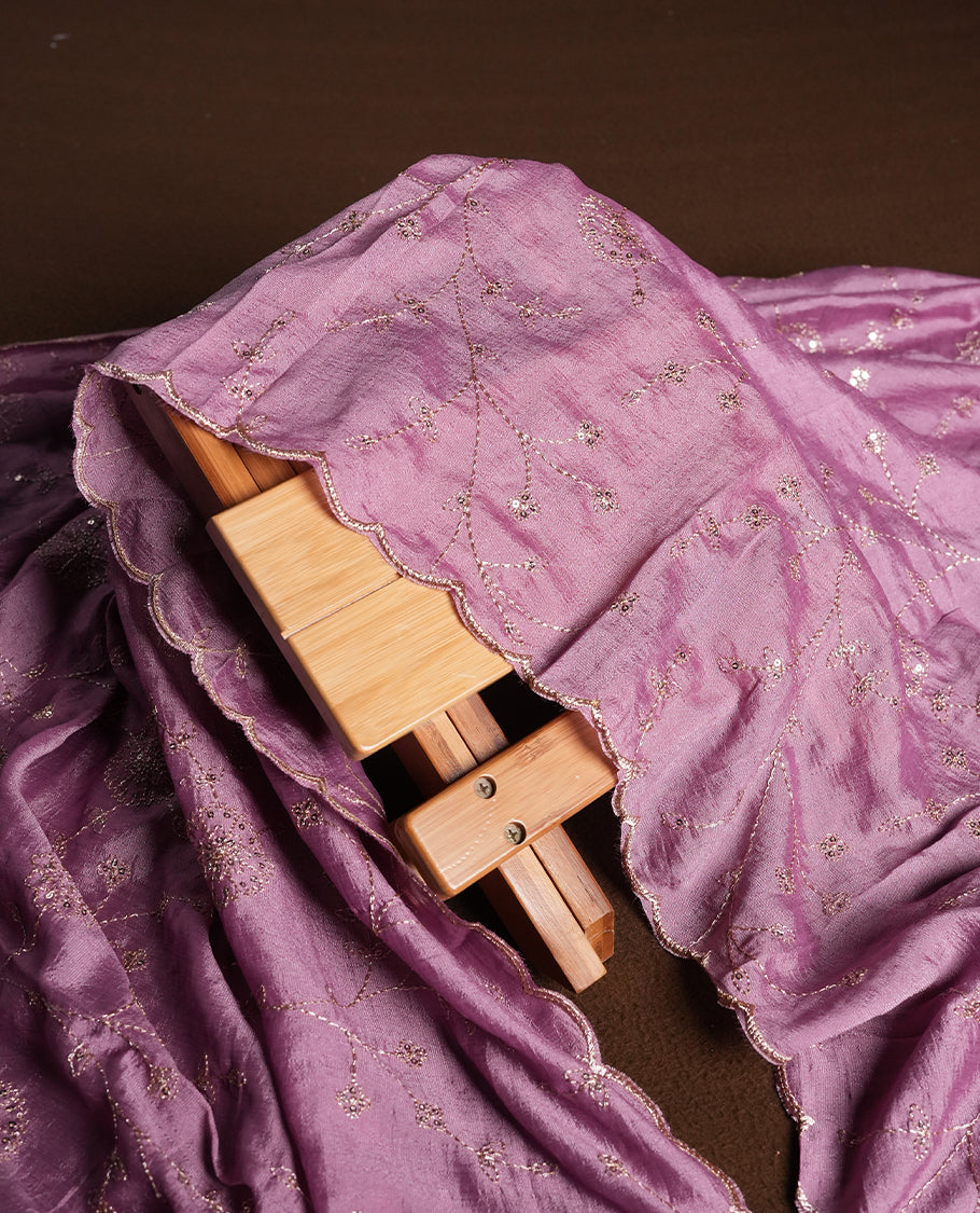 Magenta purple colour churidhar material featuring thread embroidery on the front panel, contrast lavender colour dupatta with elegant border, and matching plain bottom