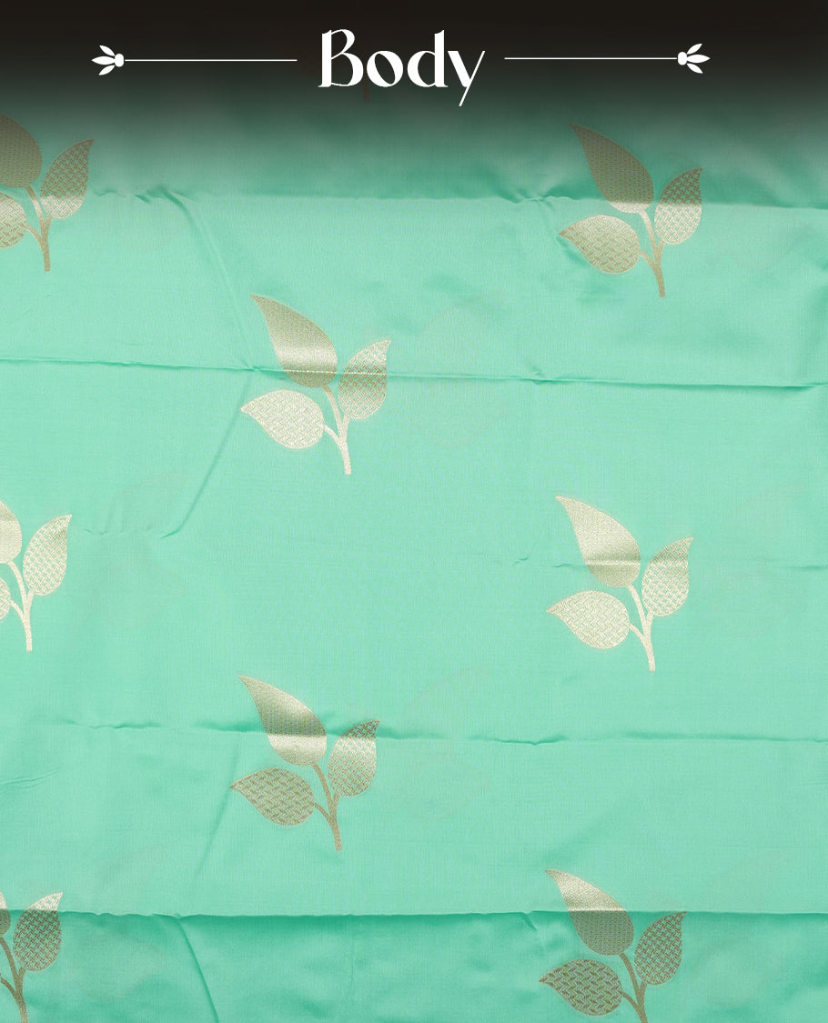 Mint green colour semi silk saree adorned with elegant floral motifs on the body, complemented by a shimmering golden zari-woven pallu and border, and paired with a matching blouse