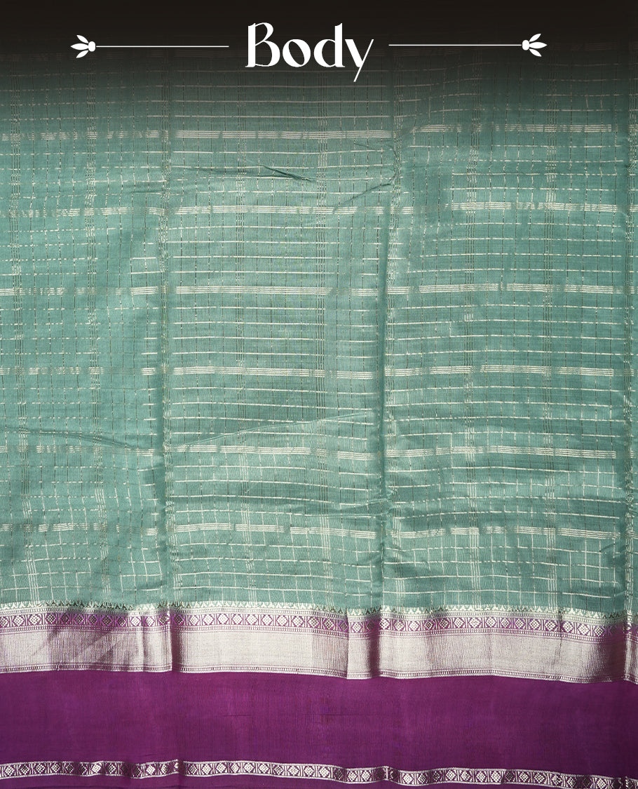 Teal green colour mixed chanderi cotton saree featuring gold checkered body, purple pallu with rose gold zari border, and matching blouse.