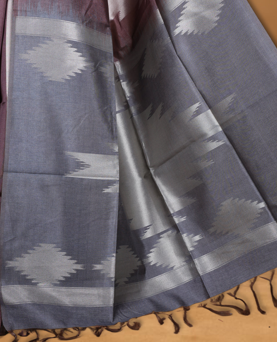 Brown and brown silver dual tone semi tussar saree featuring woven abstract geometric motifs on the body, complemented by a ikat inspired patterned pallu, paired with a matching blouse.