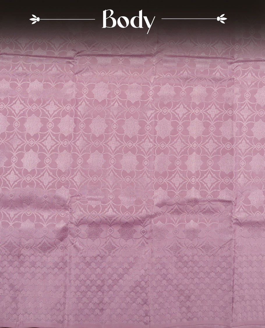 dusty lavender colour semi soft silk saree featuring a self coloured textured patterned body, complemented by self coloured pallu & border and a matching blouse piece.