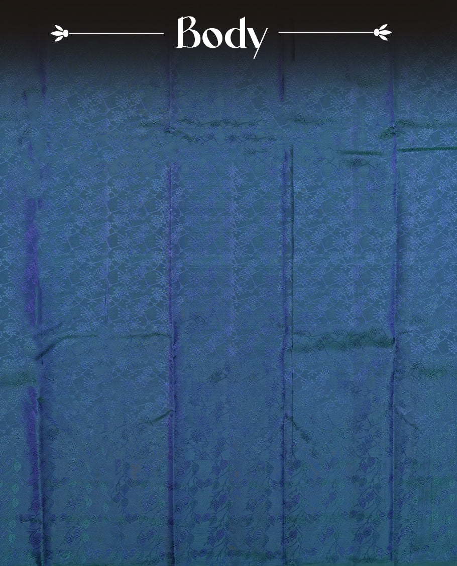 Peacock blue colour semi soft silk saree featuring a self coloured textured patterned body, complemented by self coloured tiny diamond motifes on pallu & border and a matching blouse piece.