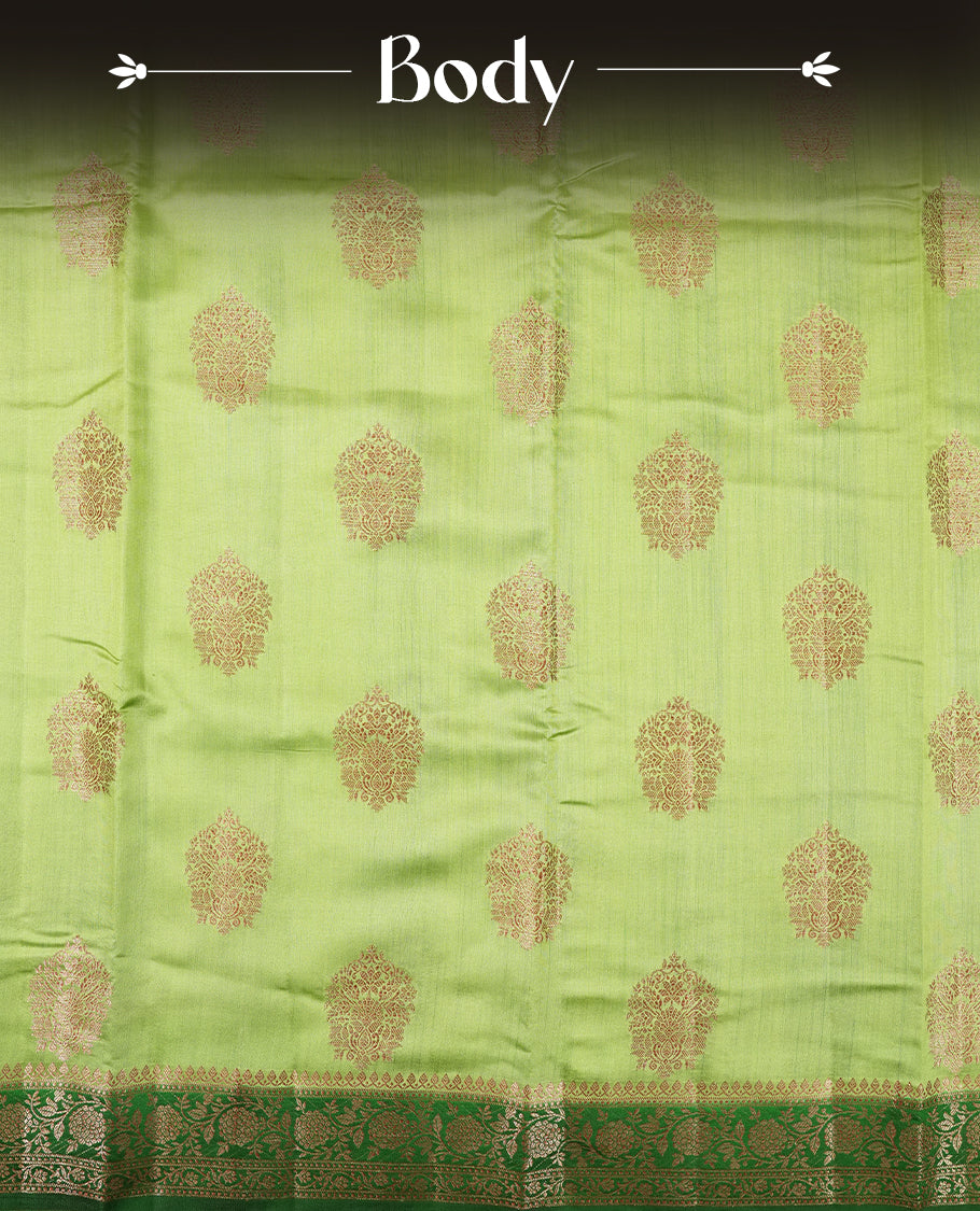 Green Colour Banaras Soft Silk Saree with Gold Zari Round Cluster Buttas, Intricate Multi-Layered Floral Border, Grand Pallu with Ornate Brocade Motifs in Deep Green and Gold Tones, and Matching Blouse.