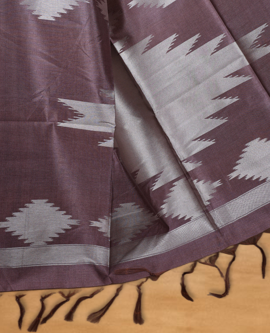 Cream and silver gold dual tone colour semi tussar saree featuring woven abstract geometric motifs on the body, complemented by a ikat inspired patterned brown pallu, paired with a matching blouse.