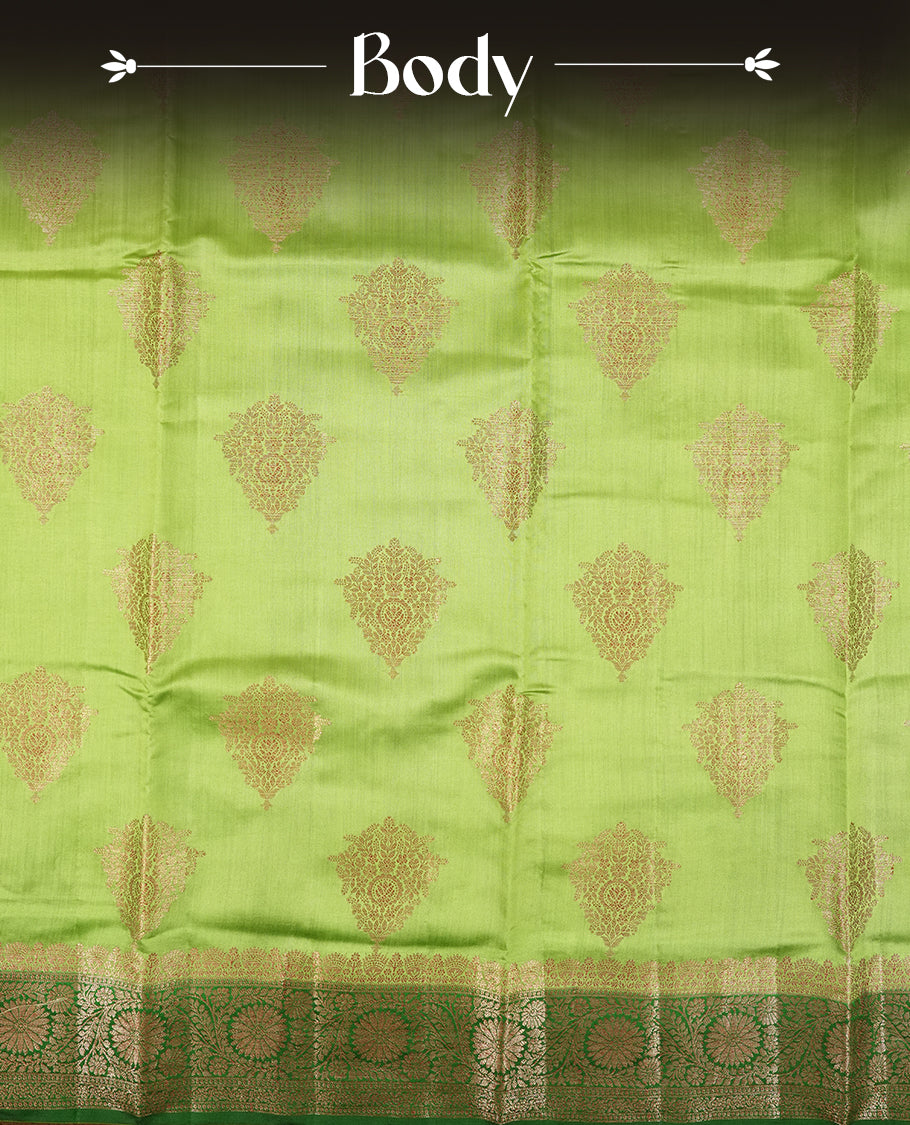 Parrot Green Colour Banaras Soft Silk Saree with Gold Zari Textured Diamond-Shaped Buttas, Simple Decorative Pallu Border, Grand Pallu with Ornate Circular and Floral Motifs in Forest Green and Gold Tones, and Matching Forest Green Blouse.