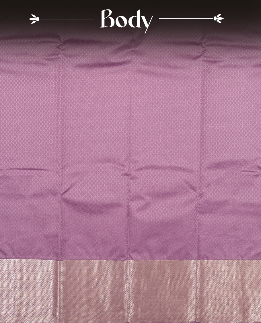 Purple Lavender colour semi soft silk saree featuring a self coloured textured patterned body, complemented by self coloured silver motifes on pallu & border and a matching blouse piece.
