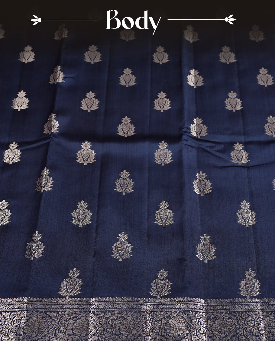 Pastel navy blue colour pure banarasi tussar soft silk saree adorned with delicate silver motifs all over the body, complemented by an intricate Banarasi style silver zari border & Comes with a matching blouse piece.
