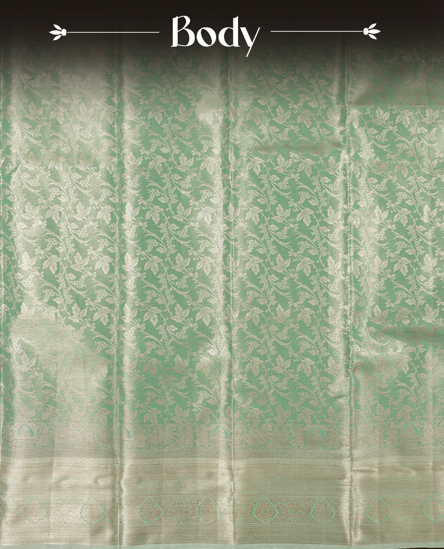 Light aqua green colour and gold Zari Tissue Brocade Saree features intricate floral Motifs on body and self coloured with traditional border & pallu, paired with matching blouse