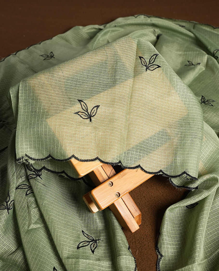 Green colour churidhar material featuring Black colour thread embroidery on the front panel, self colour dupatta with elegant border, and matching plain bottom