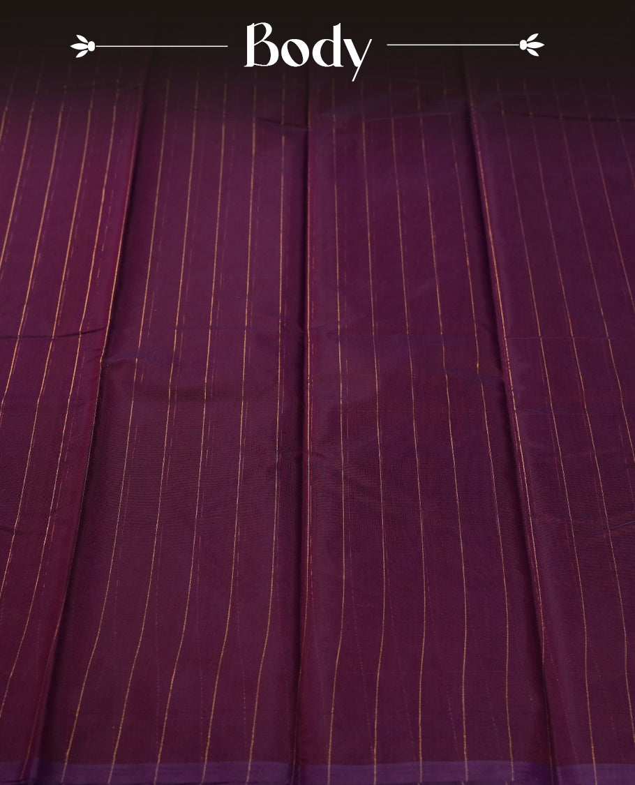 Plum purple colour silk cotton saree adorned with subtle vertical copper zari lines all over the body, crafted without a border for a minimalist charm & beige colourcontrasted border, Paired with a matching blouse for a refined, elegant look.
