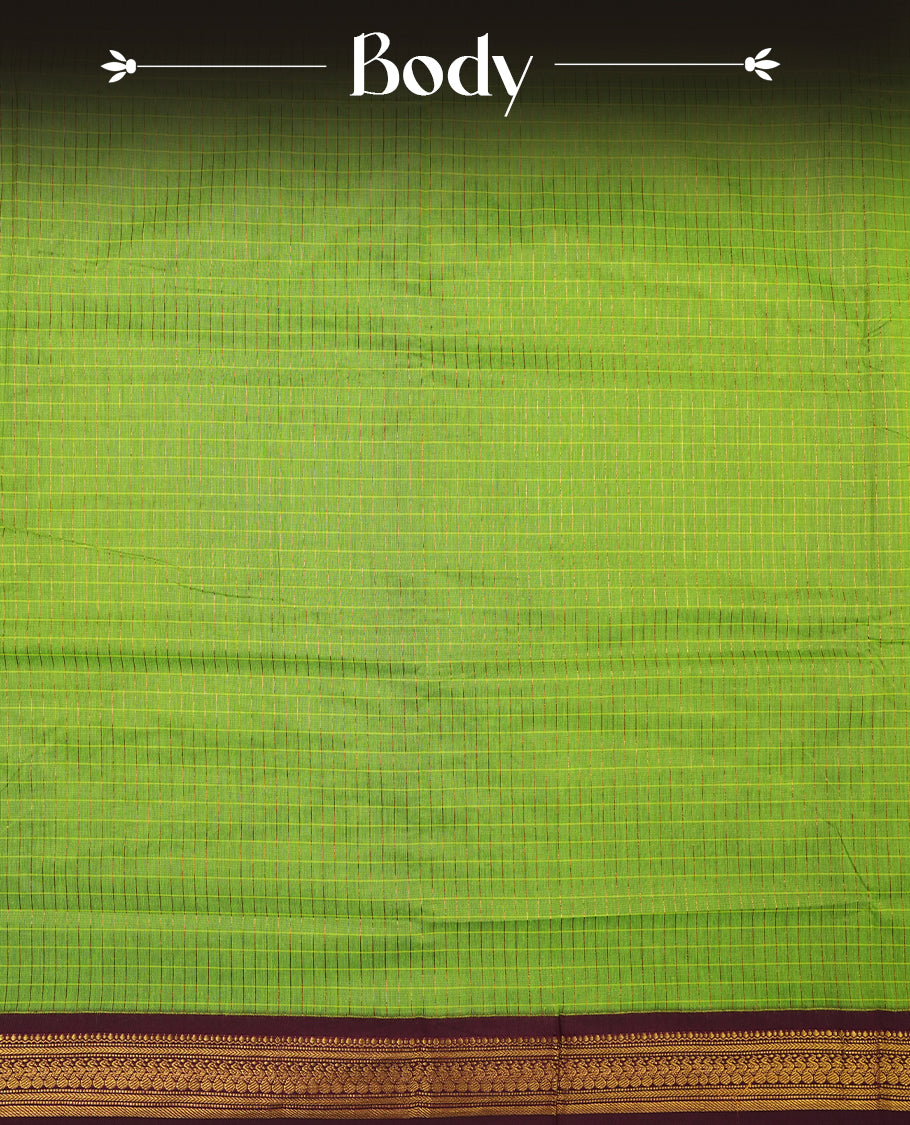 Bright Green coloured mixed Kalyani cotton saree featuring golden zari checks on the body, complemented by a rich grape coloured border and pallu adorned with golden zari patterns, Paired with a matching blouse.